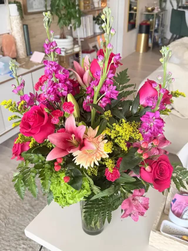A handcrafted rose arrangement by a local florist partner